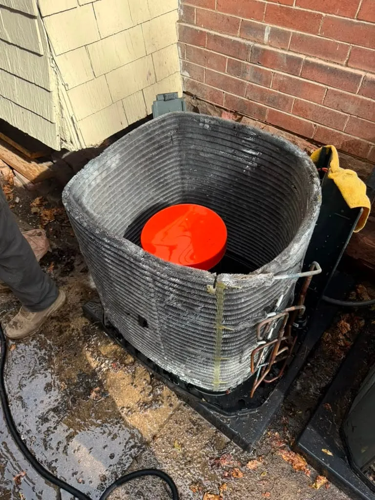 AC compressor replacement in progress by Lucas Heating and Air at a Holladay home, condenser opened with the compressor exposed