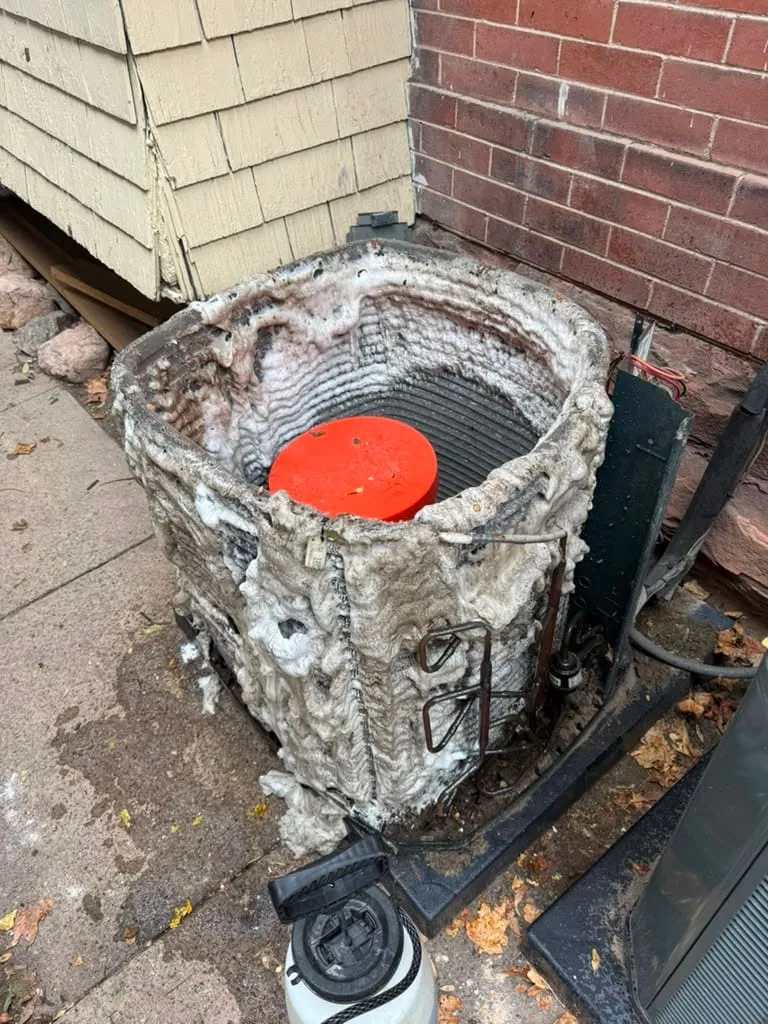 Condenser coil foaming with cleaner during a Lucas Heating and Air coil cleaning at a Holladay home