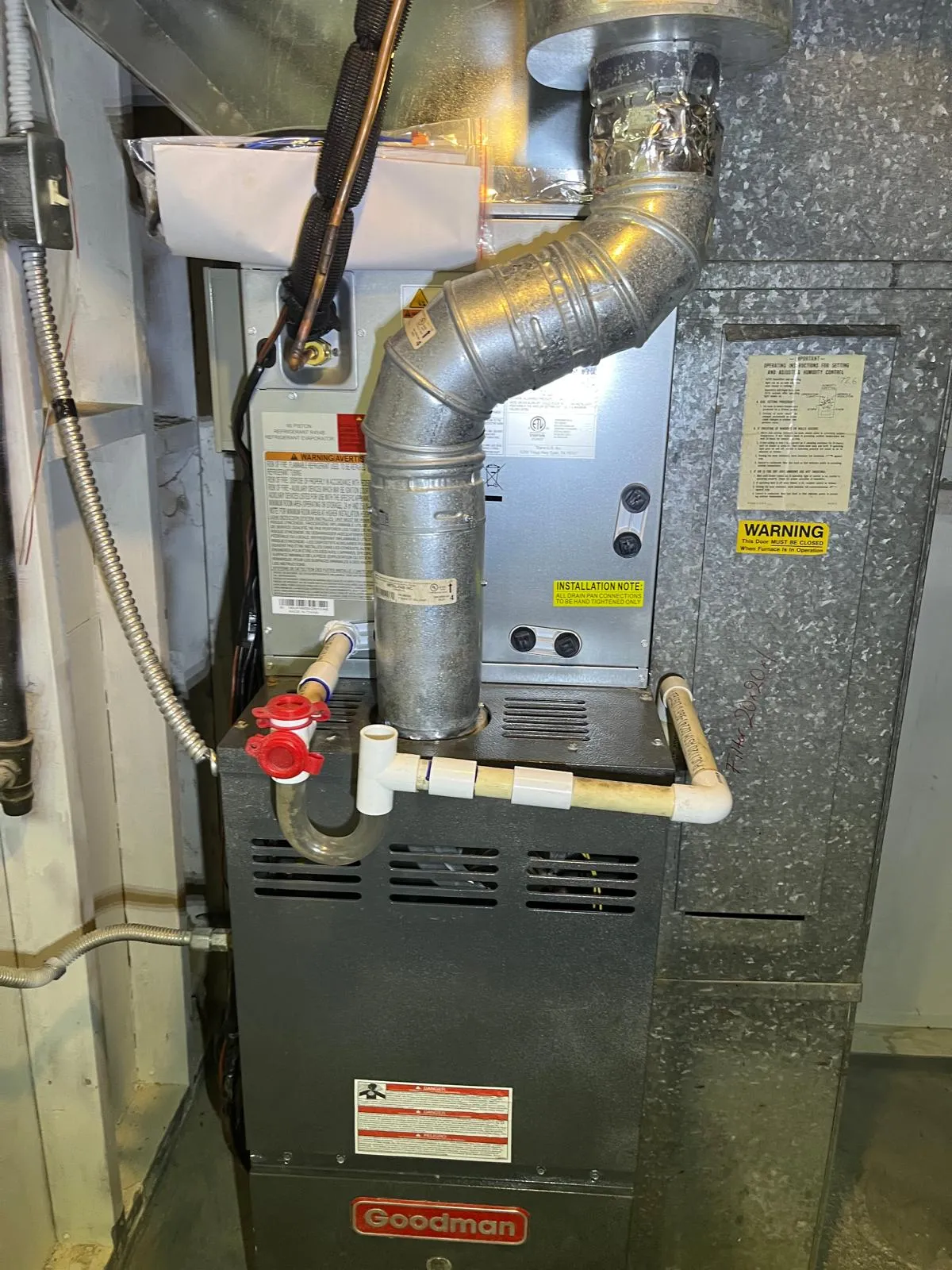 New AC evaporator coil installed above an existing Goodman furnace in a Taylorsville basement