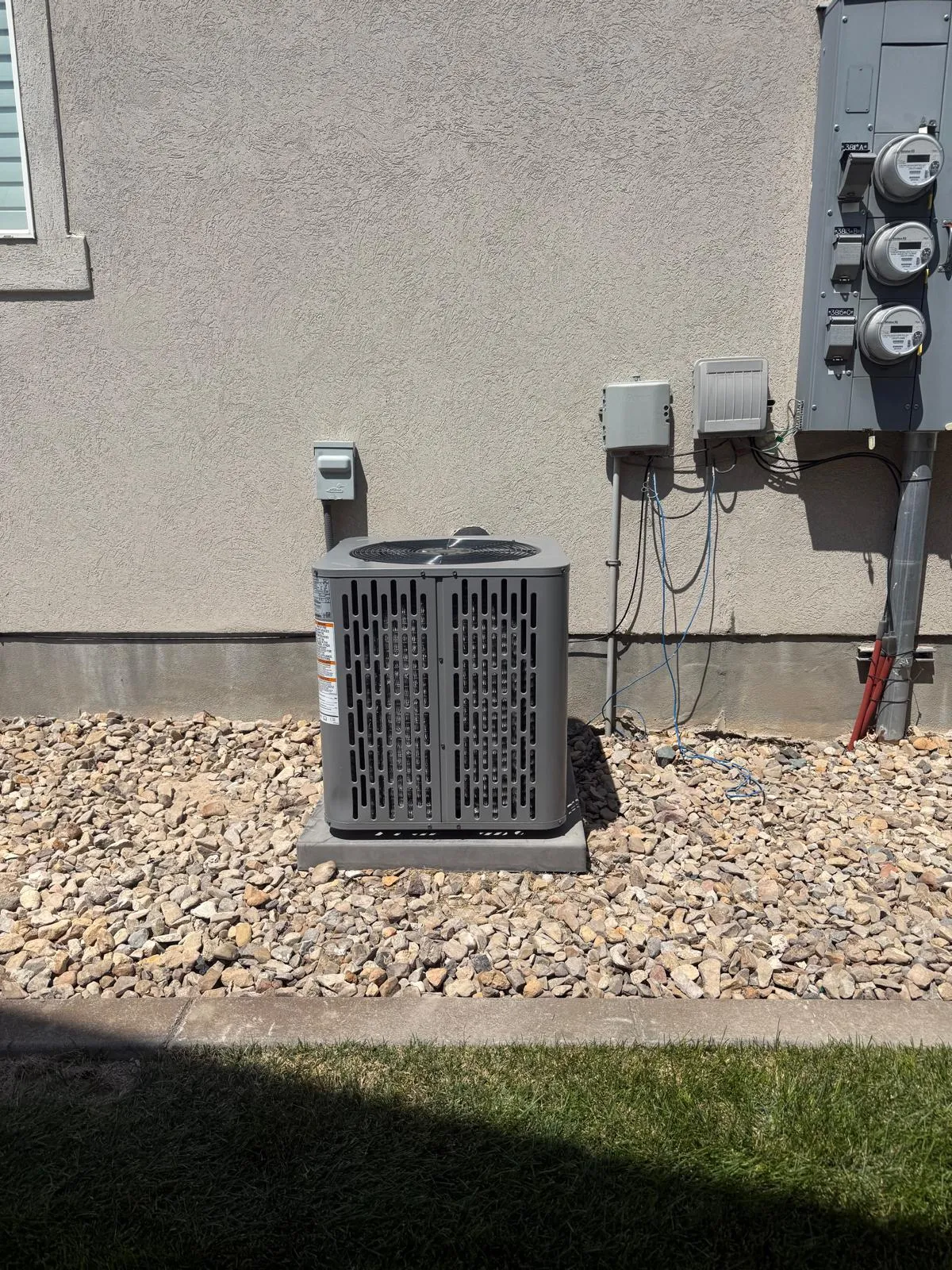 New air conditioner installed by Lucas Heating and Air beside a West Valley City home, meters and disconnect mounted cleanly