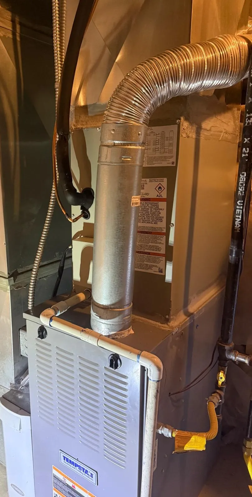 New A2L-refrigerant evaporator coil installed in a West Valley City closet by Lucas Heating and Air, with reworked flue and condensate lines