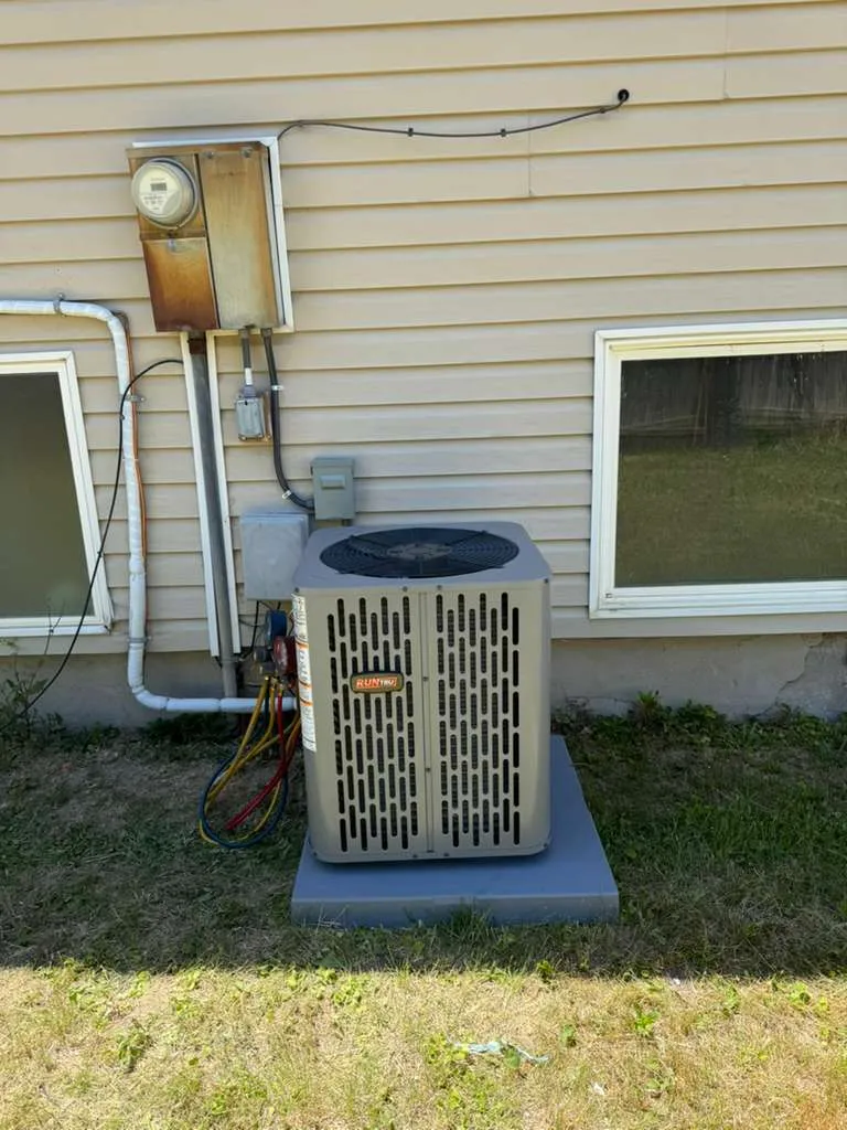 Gauge manifold connected to a new RunTru air conditioner during commissioning by Lucas Heating and Air in Magna